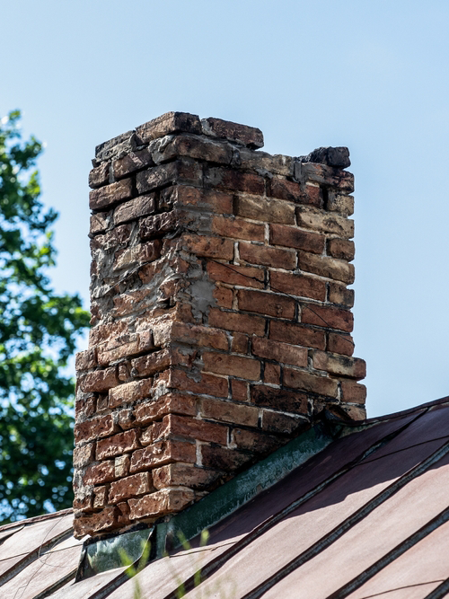 damaged chimney on a roof.