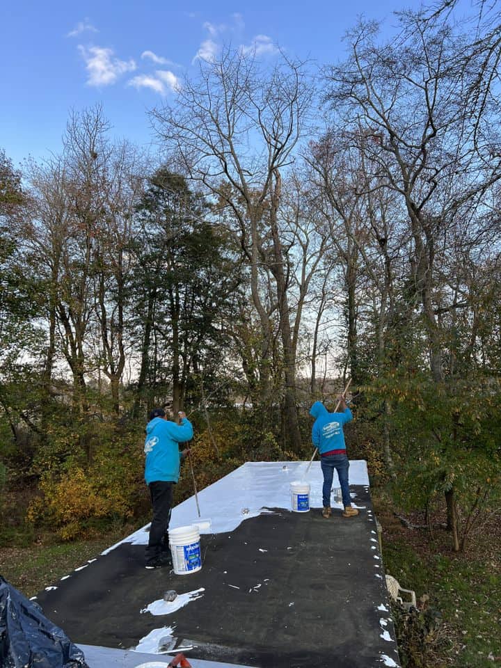 Surf & Turf Roofing professionals applying liquid coating to a mobile home roofing job