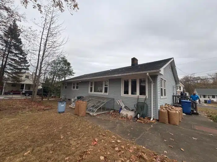 A single-story home with an aging roof—highlighting why homeowners wonder, "should I replace my roof if it's not leaking?" before making a decision.