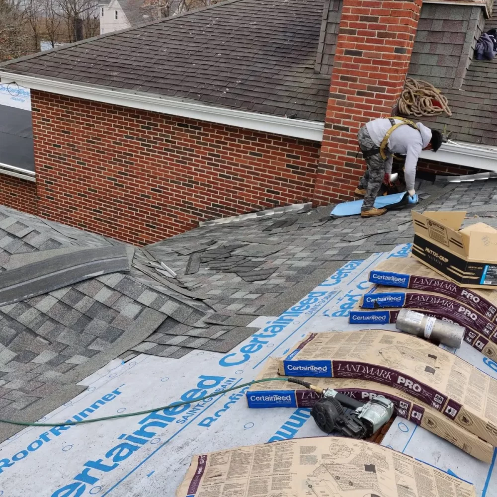 roofers installing certainteed roofing material.
